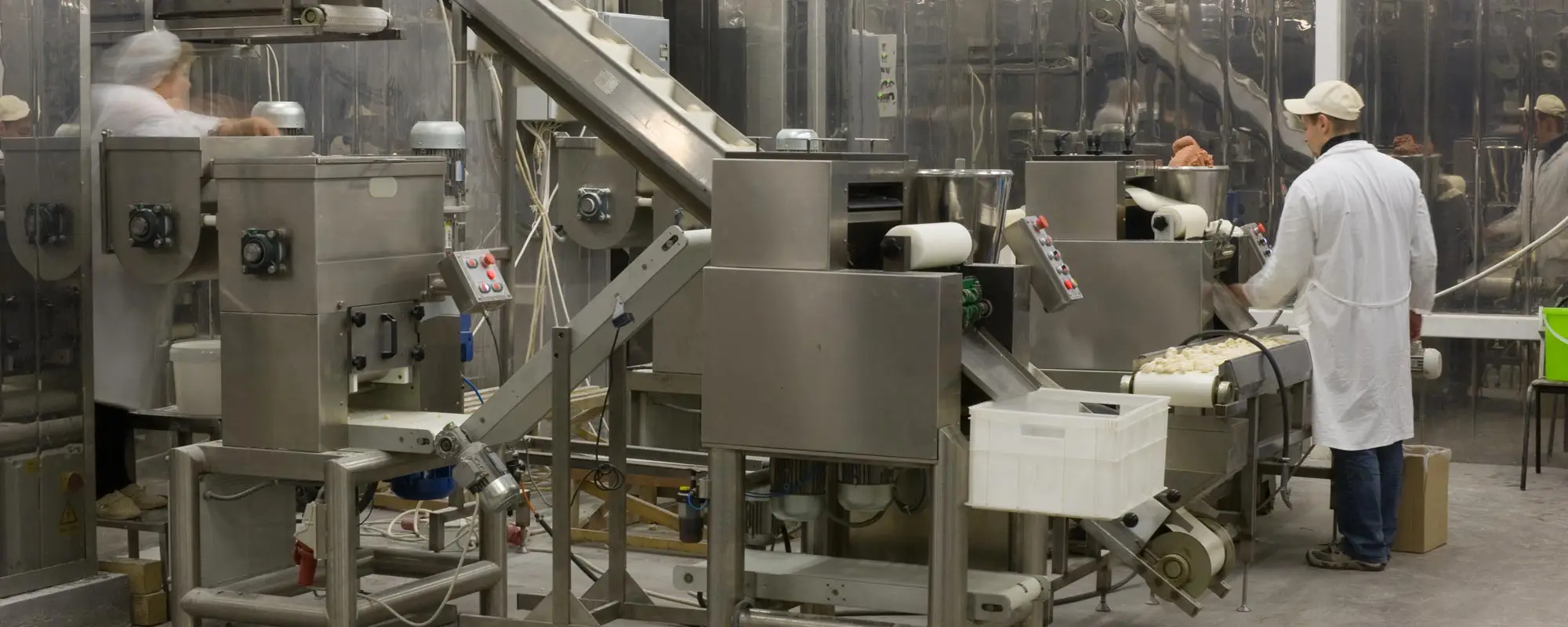 Automated production line in modern food factory. Ravioli production. People working.